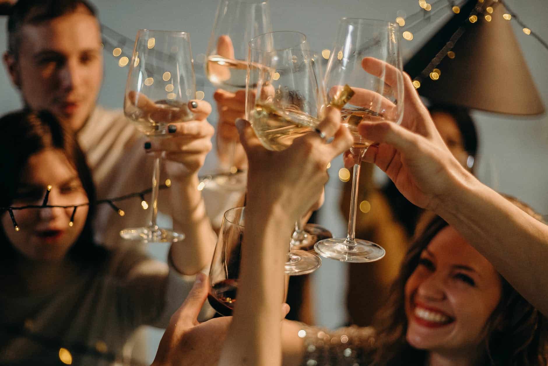 selective focus photography of several people cheering wine glasses