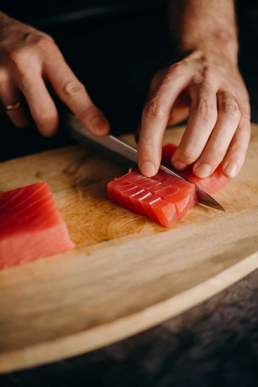 chef slicing fresh tuna meat