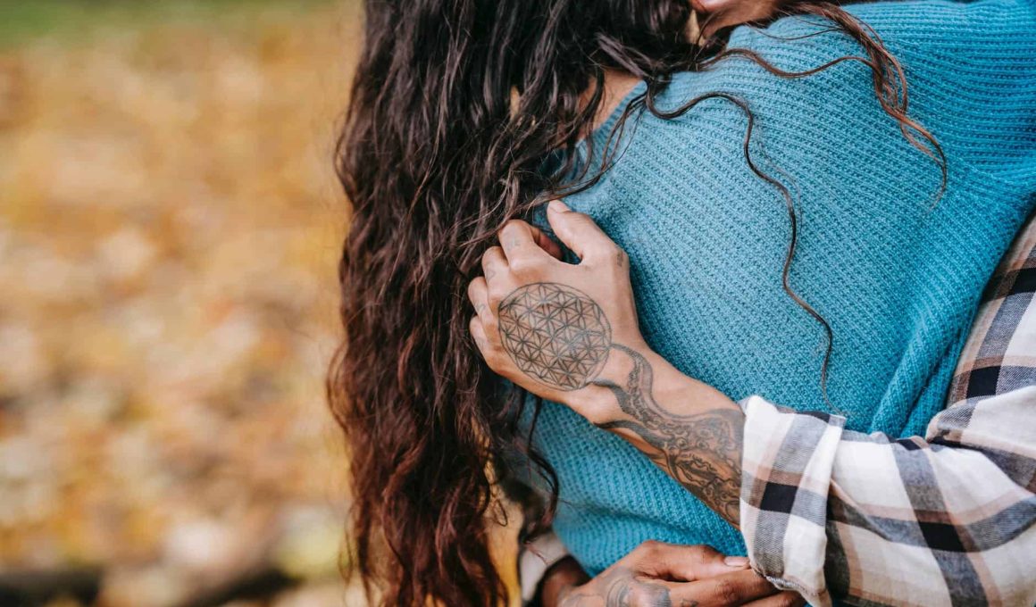 crop couple hugging in park