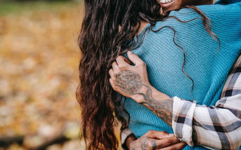 crop couple hugging in park