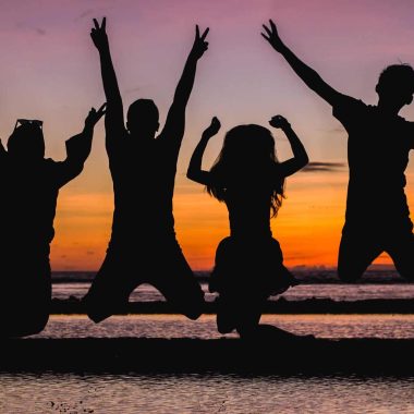 silhouette of people jumping