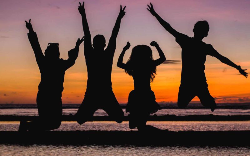 silhouette of people jumping