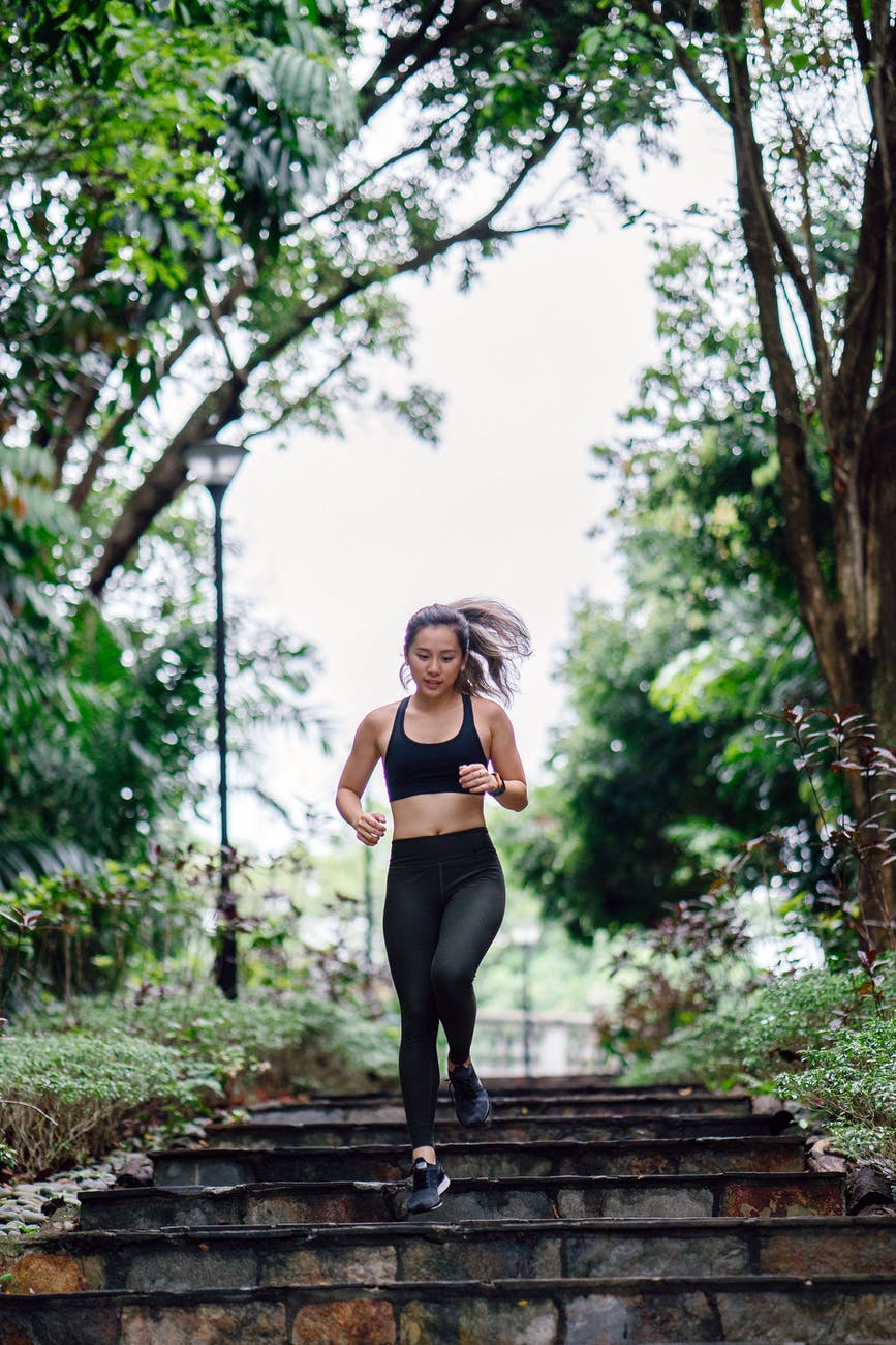 photo of woman jogging down stairs