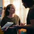 worried couple with notebook looking at each other