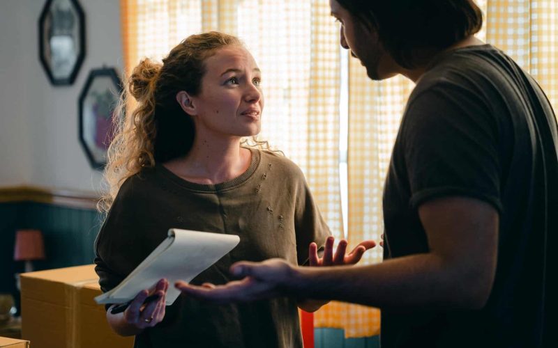 worried couple with notebook looking at each other