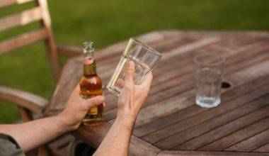 man with glass and beer bottle