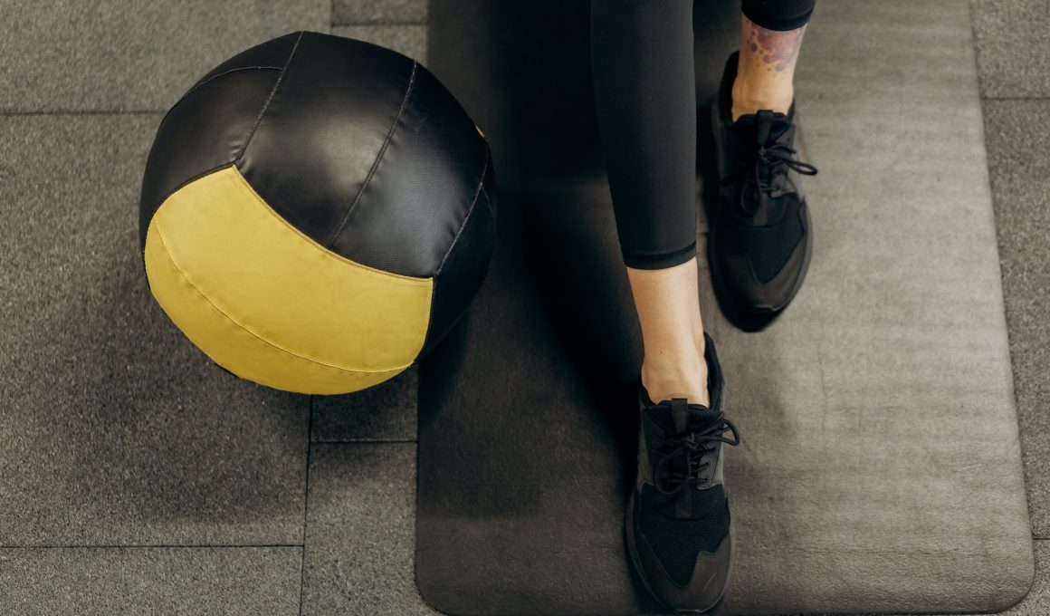 person standing on a mat beside a ball