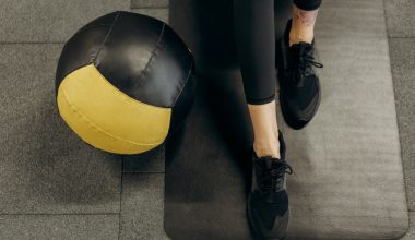 person standing on a mat beside a ball