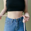 woman in black tank top and blue denim jeans