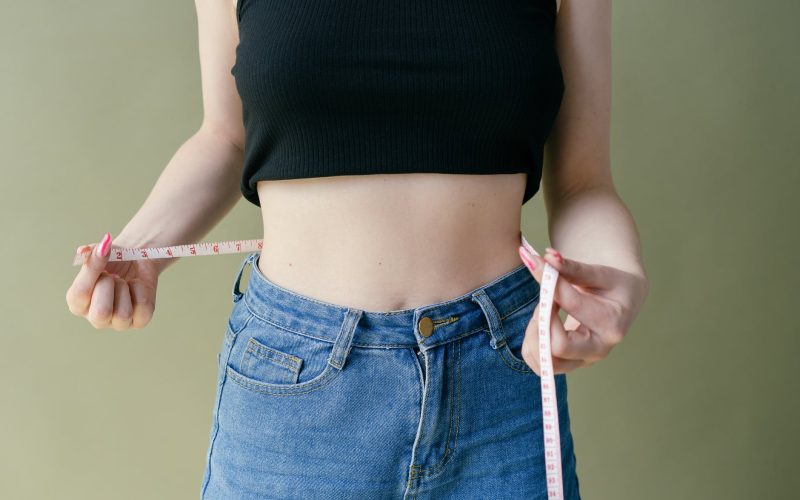 woman in black tank top and blue denim jeans