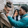 multiracial students having argument on city street