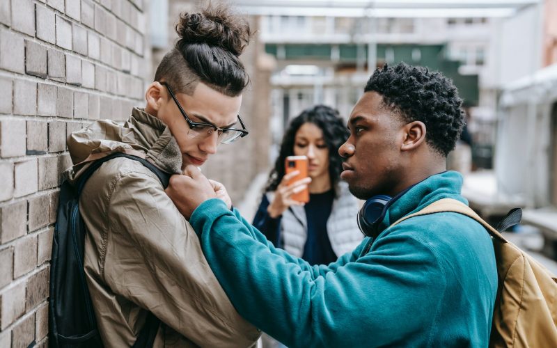 multiracial students having argument on city street