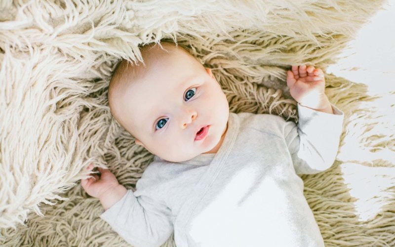 baby in white onesie