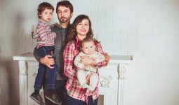 standing family near fireplace