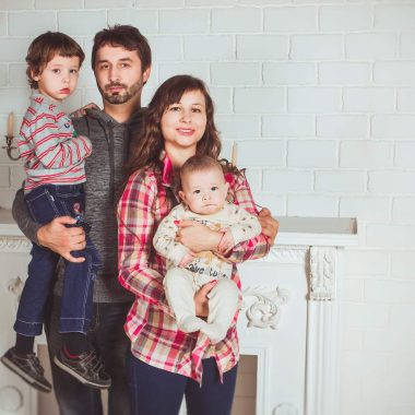 standing family near fireplace