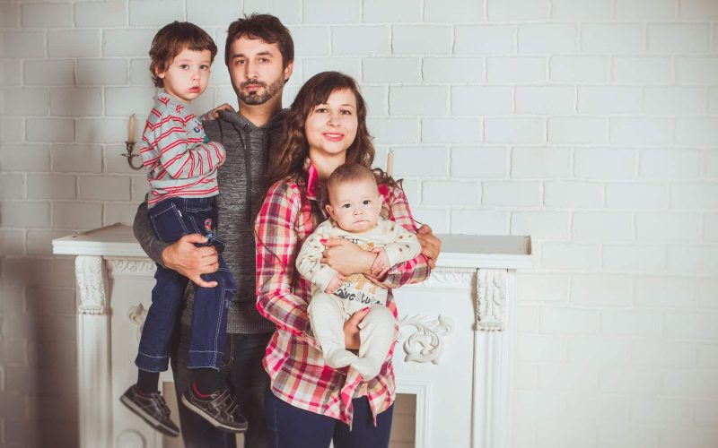 standing family near fireplace