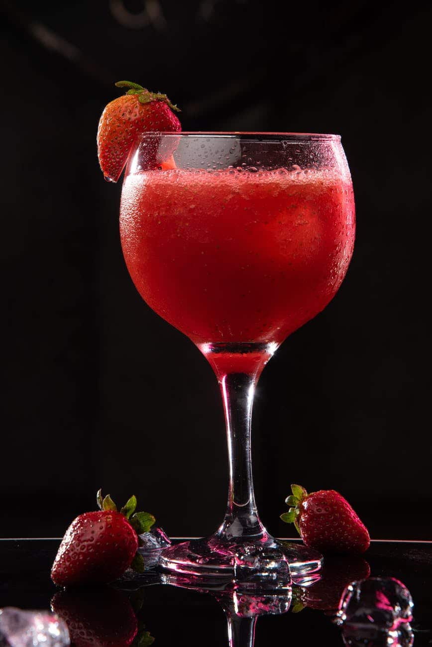 delicious bright strawberry cocktail on black background