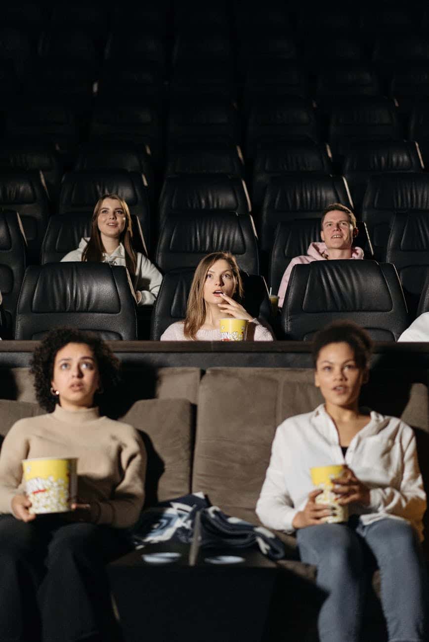 group of people sitting on black leather couch