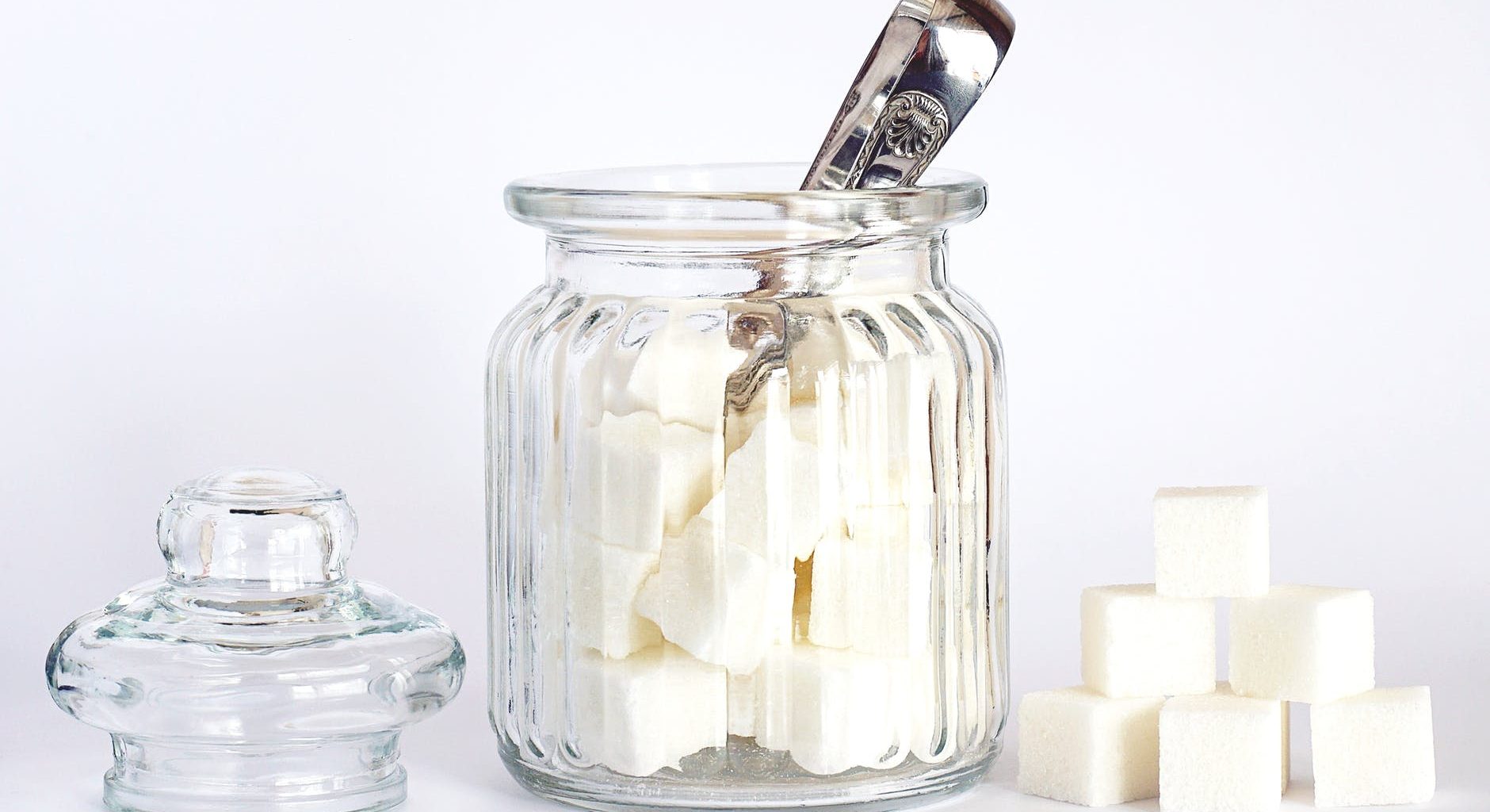 close up photo of sugar cubes in glass jar