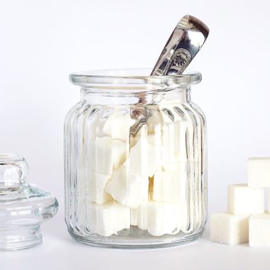 close up photo of sugar cubes in glass jar