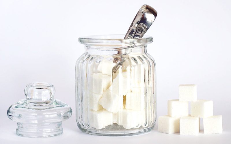 close up photo of sugar cubes in glass jar