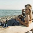 woman in black tank top sitting on brown wooden bench