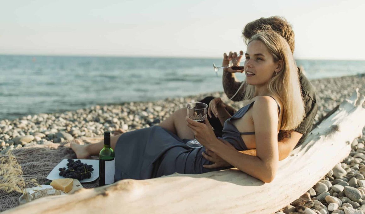 woman in black tank top sitting on brown wooden bench