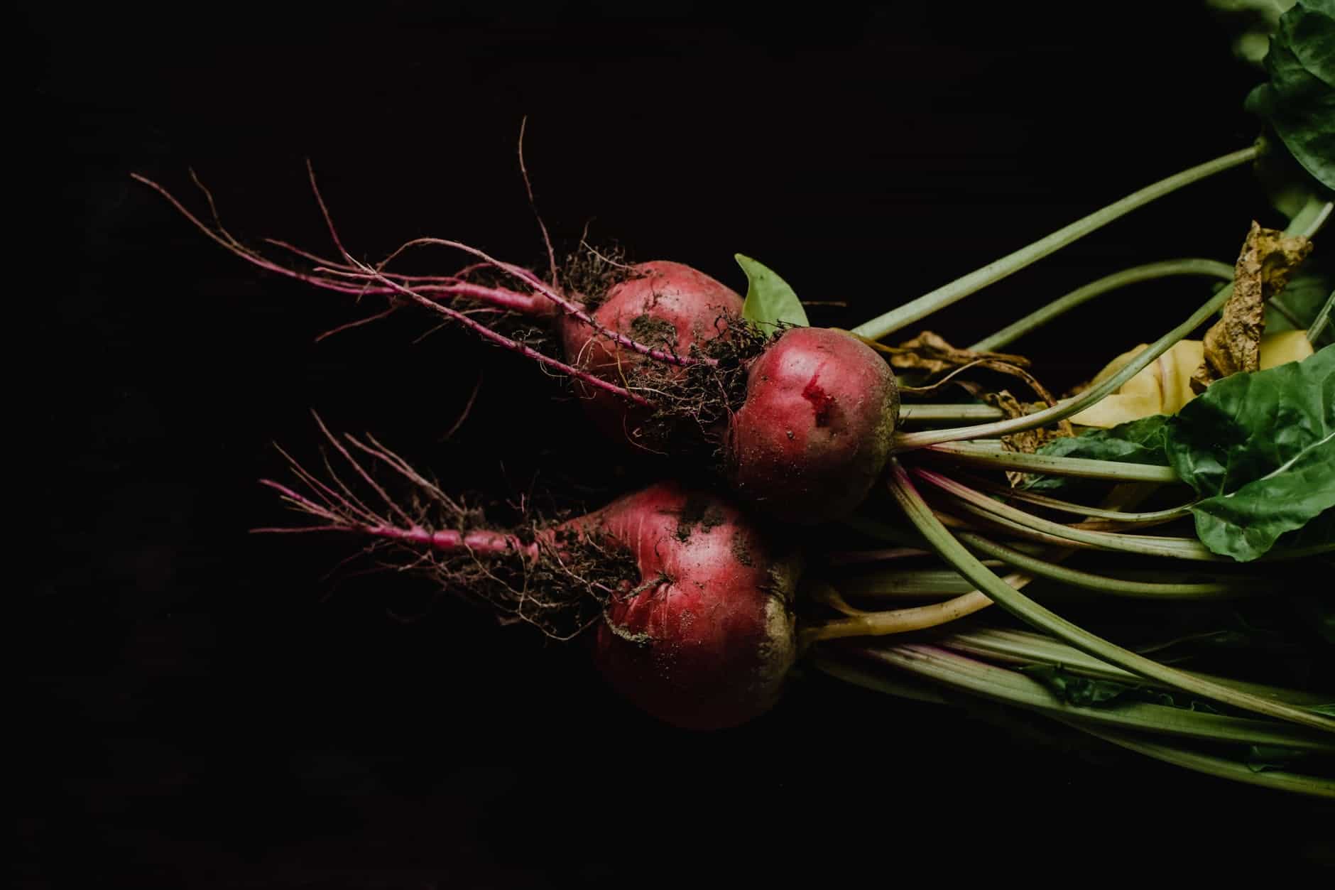 red round fruit on black background