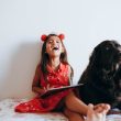 happy girl sitting beside black dog