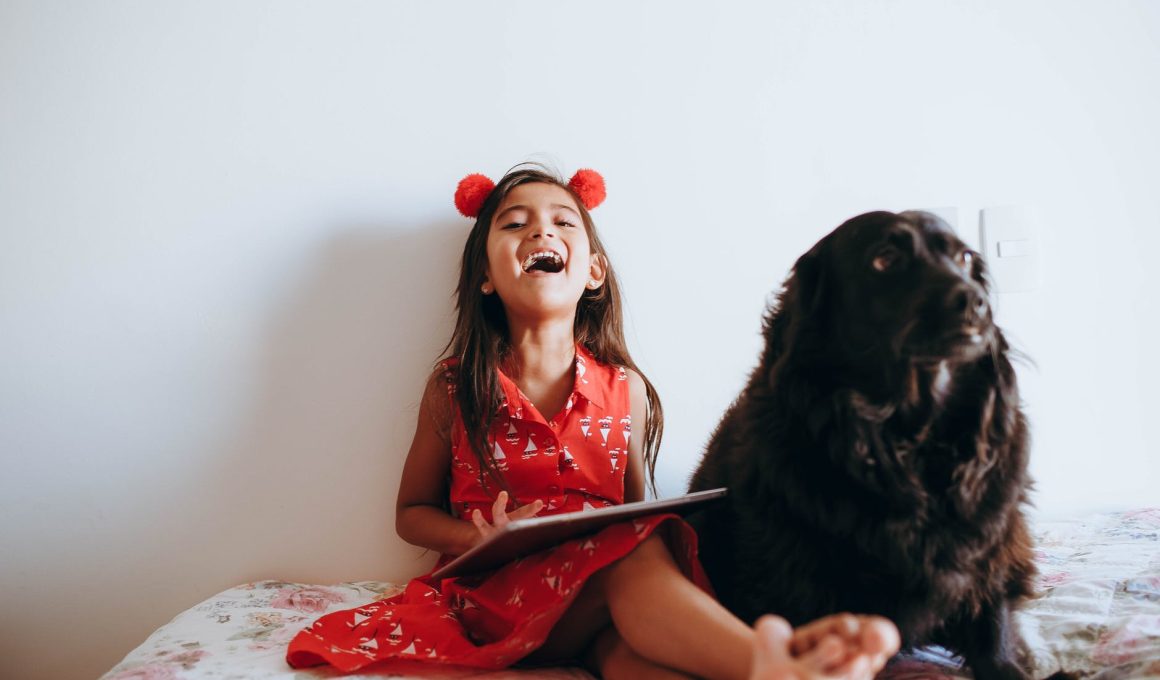 happy girl sitting beside black dog